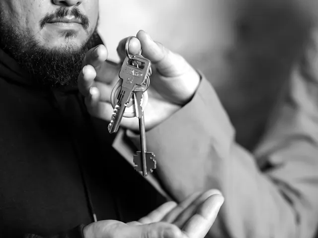 Locksmith handing over a labelled set of keys